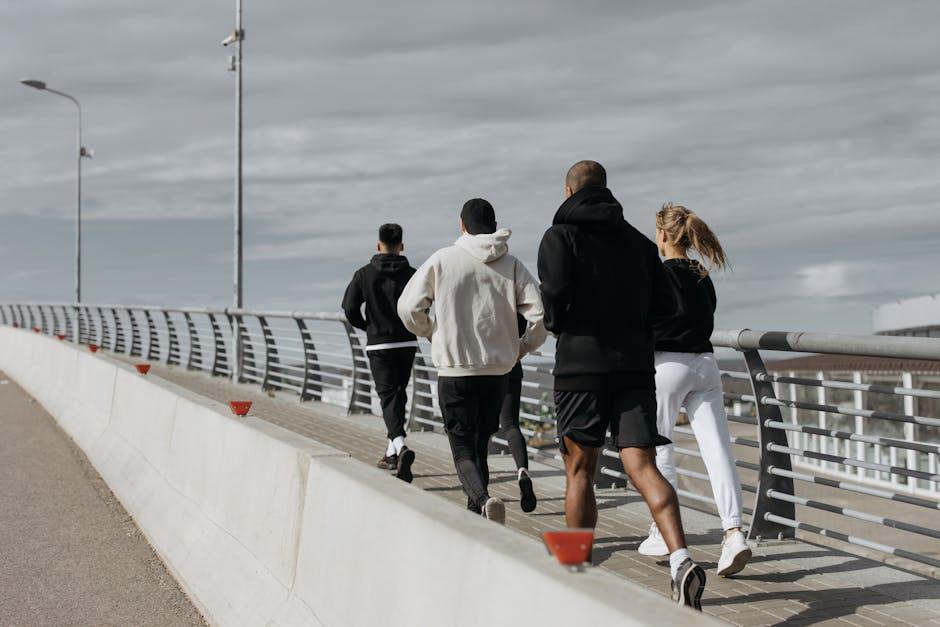 Groupe de coureurs faisant un jogging ensemble sur un pont en ville