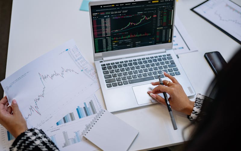 Personne analysant des graphiques et des données sur un ordinateur portable